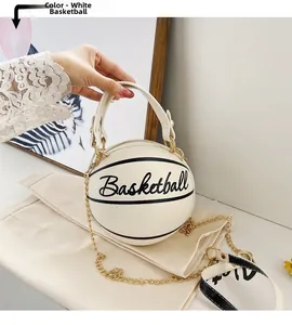 Detail view of a white basketball-shaped handbag with gold chain and top handle strap