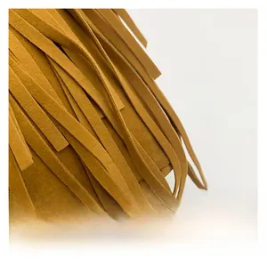 Detailed close-up of brown faux suede fringe tassels on a retro tote handbag