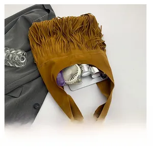 Interior view showing large capacity for tablet and cosmetics in tan tassel tote bag