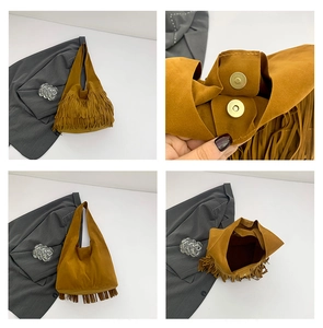 Detail view of mustard yellow suede tote featuring long fringe tassels and magnetic snap