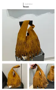 Detailed view of brown suede tote bag featuring long fringes and bohemian aesthetic
