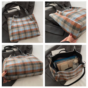 Detail view of large capacity plaid tote bag showing inner storage and strap details