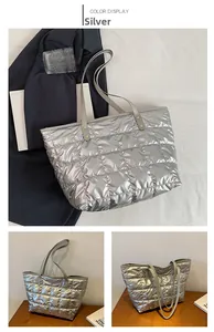 Detail of silver quilted tote bag showing checkerboard stitching and metallic luster texture