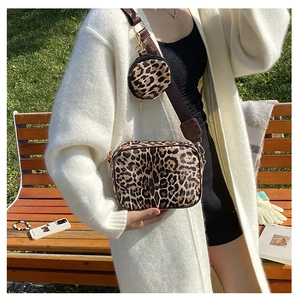 Detailed shot of leopard print crossbody bag set with adjustable strap on white sweater