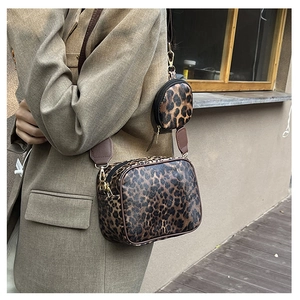 Chic leopard print crossbody bag set with round coin purse on a stylish fashion model