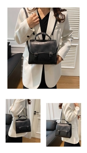 Detail of British style black satchel with lychee texture leather and silver buckles
