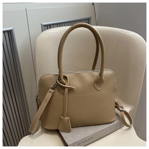 Detail of khaki bowling bag with litchi texture PU leather and detachable strap
