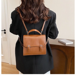 British style caramel PU leather Cambridge mini backpack with adjustable straps on a model