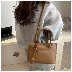 Brown matte leather handbag with white contrast stitching for professional office settings