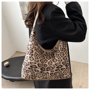 Detail of suede leopard print tote bag showing the textured fabric and shoulder strap