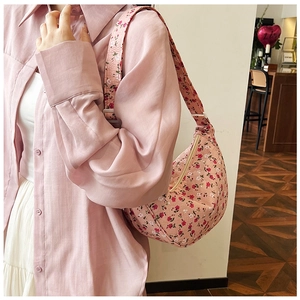 Close-up of floral canvas hobo bag with pink flower pattern and adjustable strap