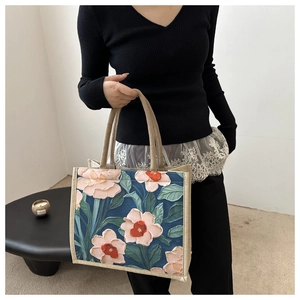 Detailed close-up of 3D embossed oil painting flower pattern on linen tote bag surface