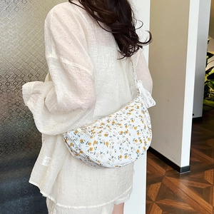 Floral canvas crescent crossbody bag with lace details and a vintage aesthetic