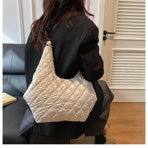 Detailed view of quilted metallic tote bag with diamond stitching and puffer style