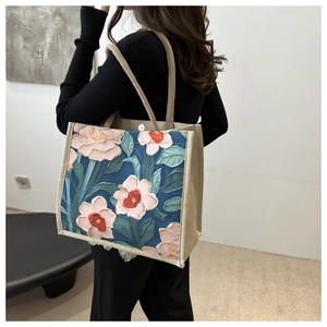 Detail of artistic floral linen tote bag with 3D impasto flower texture and hemp handles