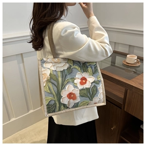 Detail of linen tote bag featuring white floral oil painting pattern with relief texture