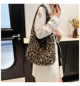 Femme portant un grand sac cabas en peluche léopard avec un manteau blanc chic