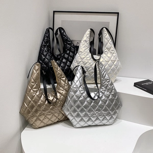 Quilted metallic puffer tote bags in black, gold, silver and white on a minimalist stand
