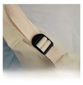 Detail of adjustable cotton canvas shoulder strap with black plastic buckle for tote bag