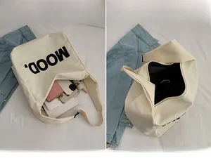 Detailed interior view of a beige canvas tote bag showing large storage capacity