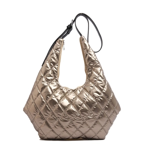 Champagne gold quilted puffer tote bag with metallic finish and black adjustable strap