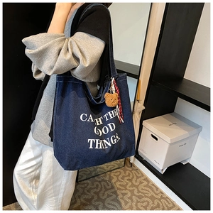 Casual large denim tote bag in dark blue with artistic lettering and bear charm