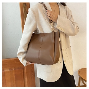 Caramel brown large capacity tote bag with vertical stitching and leather shoulder straps