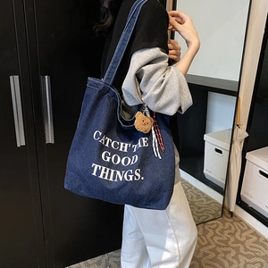 Deep blue denim tote bag with Catch the Good Things slogan and bear plush charm
