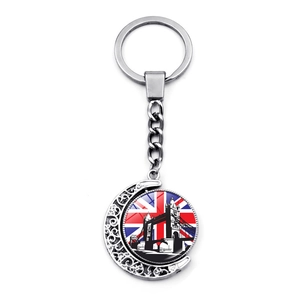 Rotating London Tower Bridge keychain with Union Jack design on silver crescent moon pendant