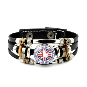 Detail of multi-layer leather bracelet with British flag emblem and England charms
