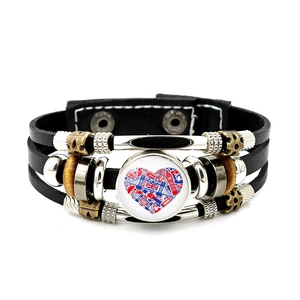 Detailed macro view of woven leather bracelet featuring London Tower Bridge and Big Ben charm