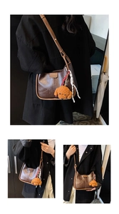 Detail of brown half-moon bag with plush puppy charm and printed silk scarf