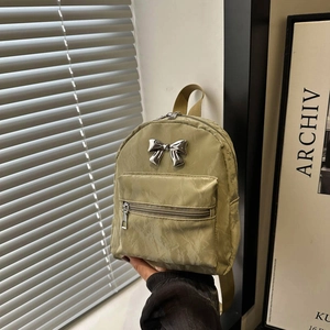 Olive green mini backpack with silver bow accent and crinkle texture for casual travel