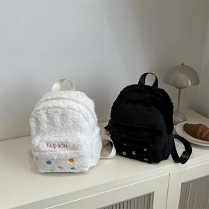 Plush faux fur mini backpacks in black and white with fashion embroidery and straps