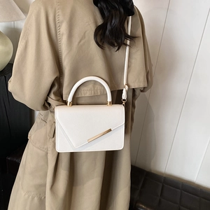 Minimalist white litchi textured leather crossbody bag with gold hardware detail