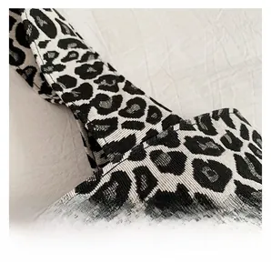 Detailed macro view of leopard print canvas bag showcasing neat stitching and woven texture