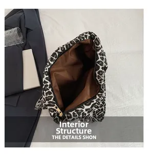 Macro detail of leopard print tote bag interior with zipper closure and brown lining