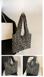 Detail of black leopard print canvas tote bag with wide strap and spacious interior