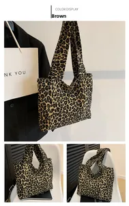 Detail view of large leopard print canvas tote bag with wide strap and brown animal patterns