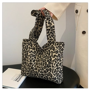 Macro view of leopard print canvas tote bag with wide strap and high-quality texture