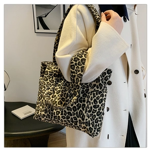Detailed view of the leopard print tote bag featuring sturdy canvas straps and large capacity