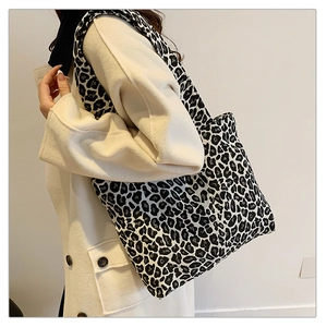 Leopard print tote bag styled with a plush coat for a chic seasonal look
