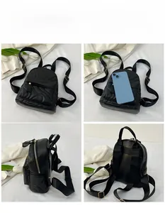 Detailed view of quilted leather mini backpack showing size comparison with a phone