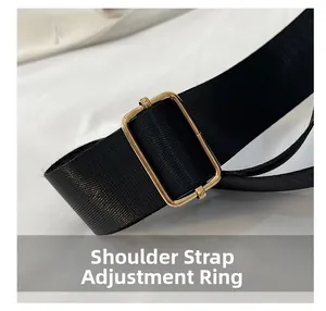 Detail of adjustable black nylon strap with a polished gold-finish metal buckle