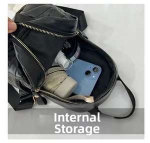 Top view of compact black quilted backpack interior showing storage space for phone and umbrella