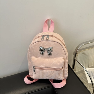 Pink mini backpack with bow detail and crinkled texture for stylish women's travel