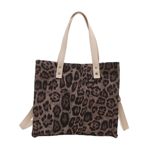 Retro leopard print tote bag with cream handles and adjustable shoulder strap on white base