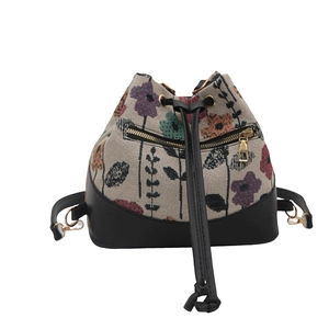Ethnic style bucket bag with floral jacquard fabric and black faux leather base