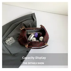 Top view of large vintage plaid shoulder bag showing spacious interior with personal items