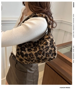 Close-up of leopard print plush tote bag showing soft faux fur texture and handle
